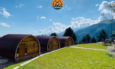 Wooden huts inside dense forest of Sharan Valley