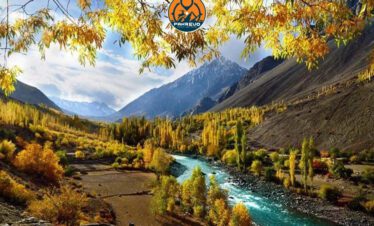 The Hunza River flows through a lush green valley near Shigar