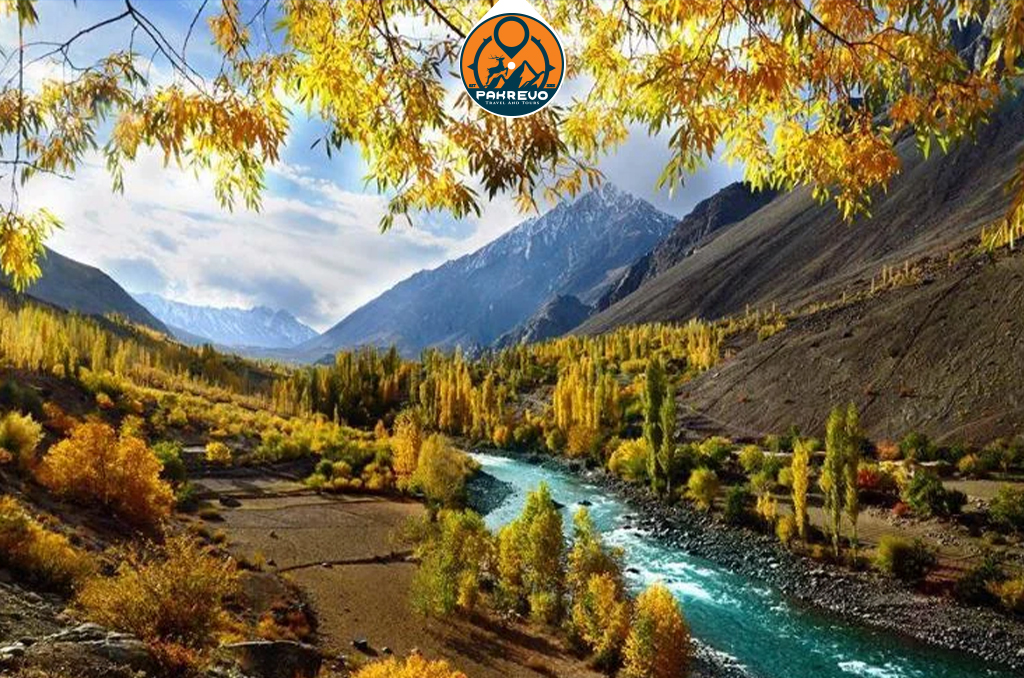 The Hunza River flows through a lush green valley near Shigar