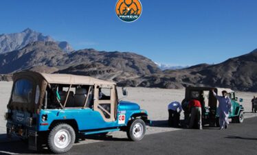 Jeep convoy traversing the vast Deosai Plains landscape