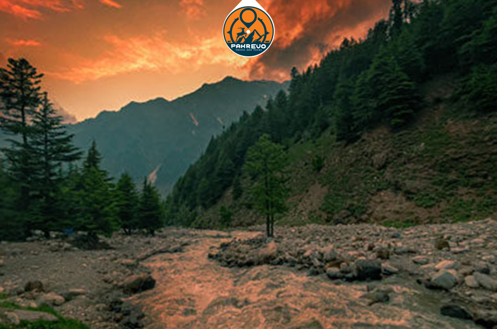 Sunset over Shogran hills with a golden sky above the pine-covered landscape