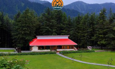 Local village life near Shogran with wooden cottages and lush surroundings