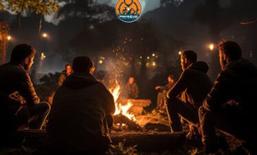 Colleagues networking around a bonfire at Shogran dusk