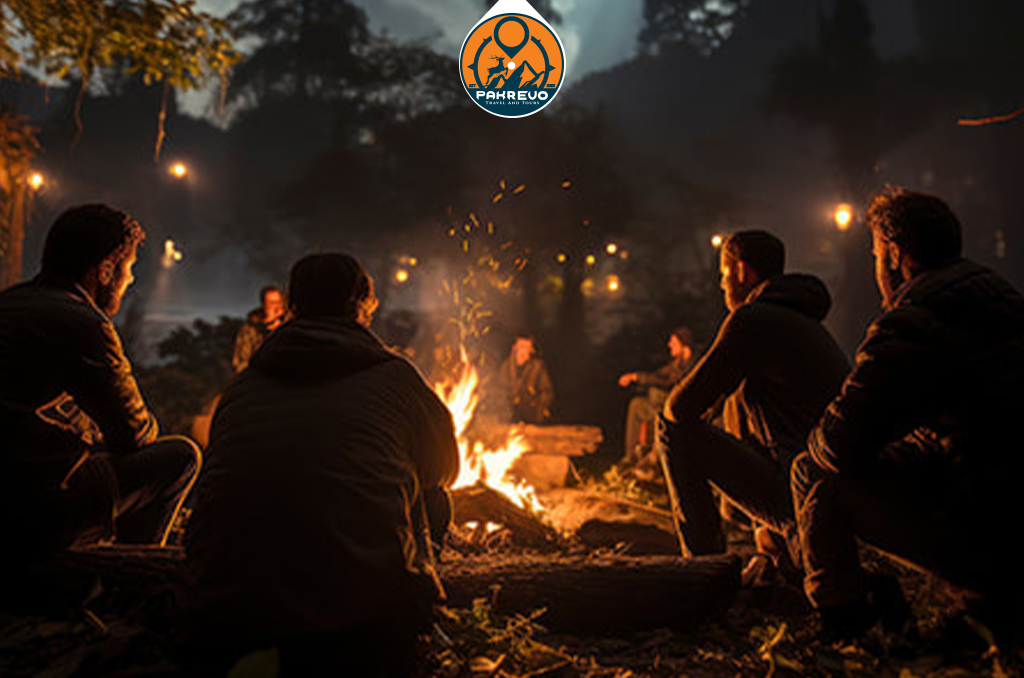 Colleagues networking around a bonfire at Shogran dusk