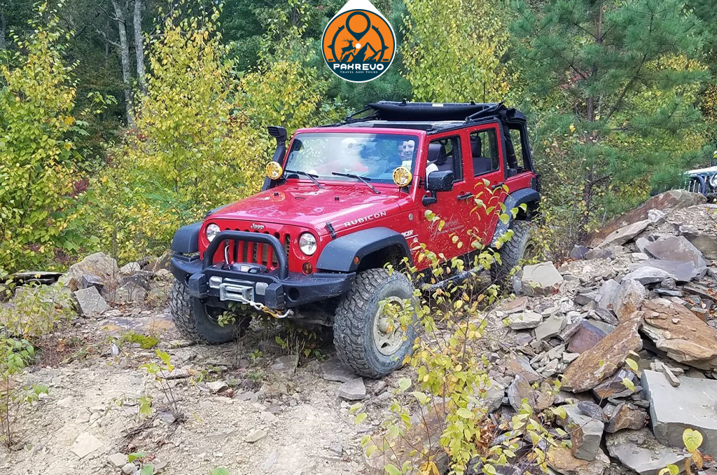 Tourist jeep navigating scenic dirt road in Siran Valley