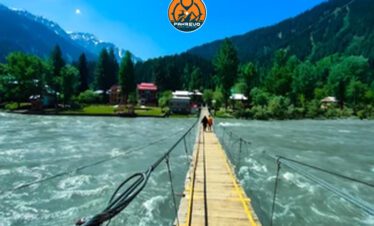 Students crossing a suspension bridge over Neelum River