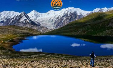 Youth group hiking through alpine meadows toward Rush Lake