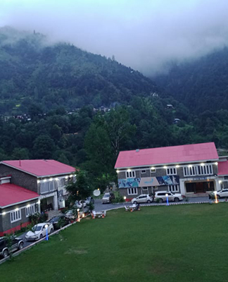 Keran Resort in Neelum Valley with riverside cottages, lush gardens, and views of the Neelum River and surrounding mountains