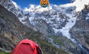 Trekker looking towards Ultar Base Camp in Hunza Valley